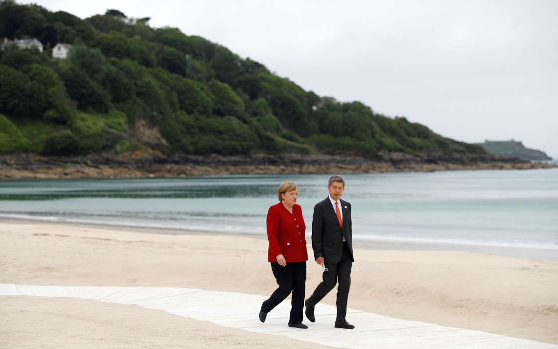 German Chancellor	Angela Merkel walking around the beach at G7 summit 2021